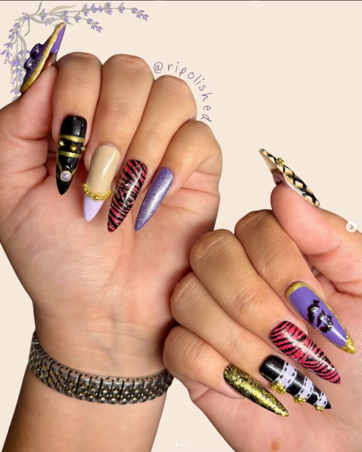 Riri’s long purple, gold and black statement nail art